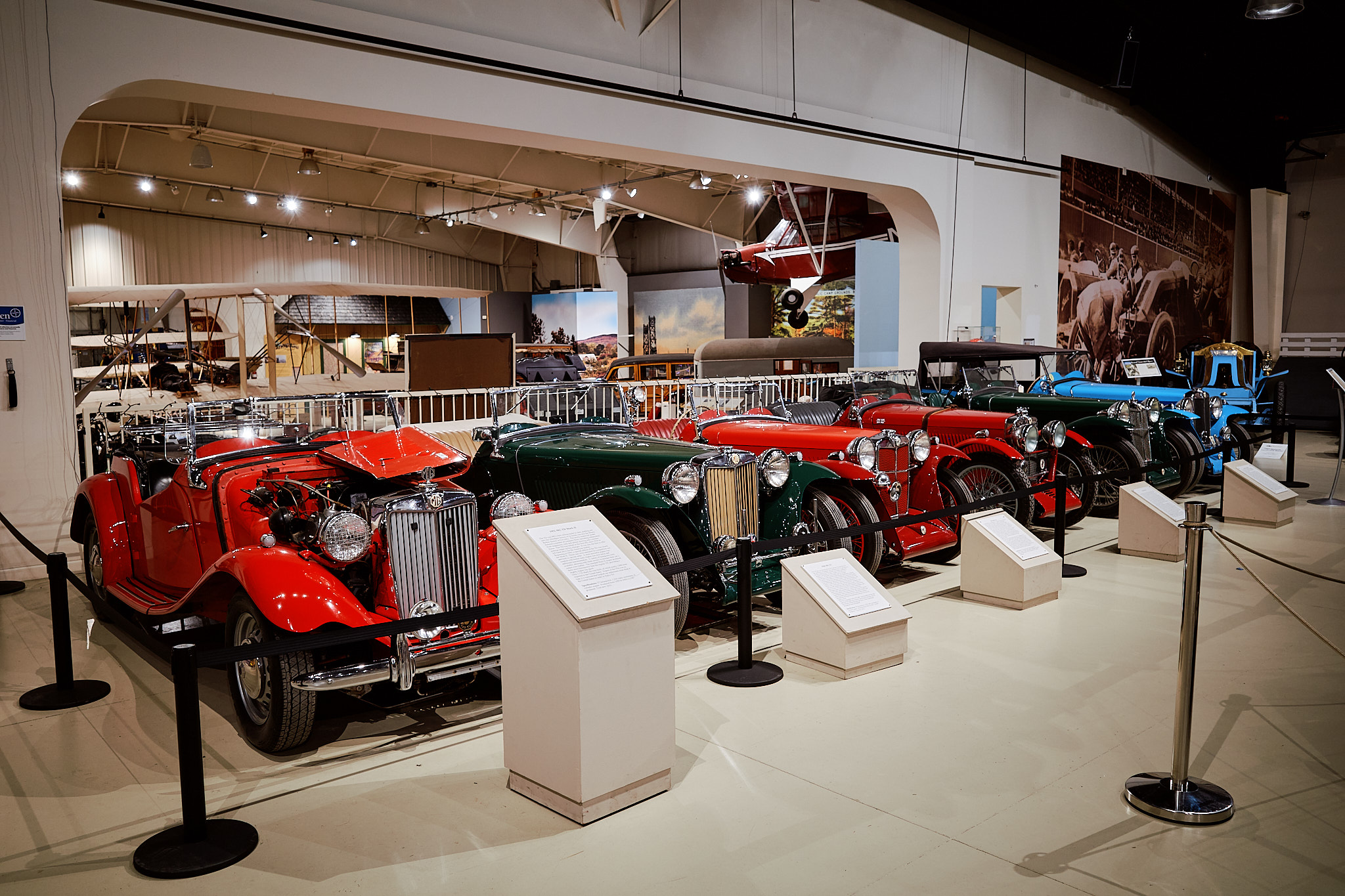 Ricoh GR III SDR JPEG of vintage red cars displayed in a brightly lit museum.
