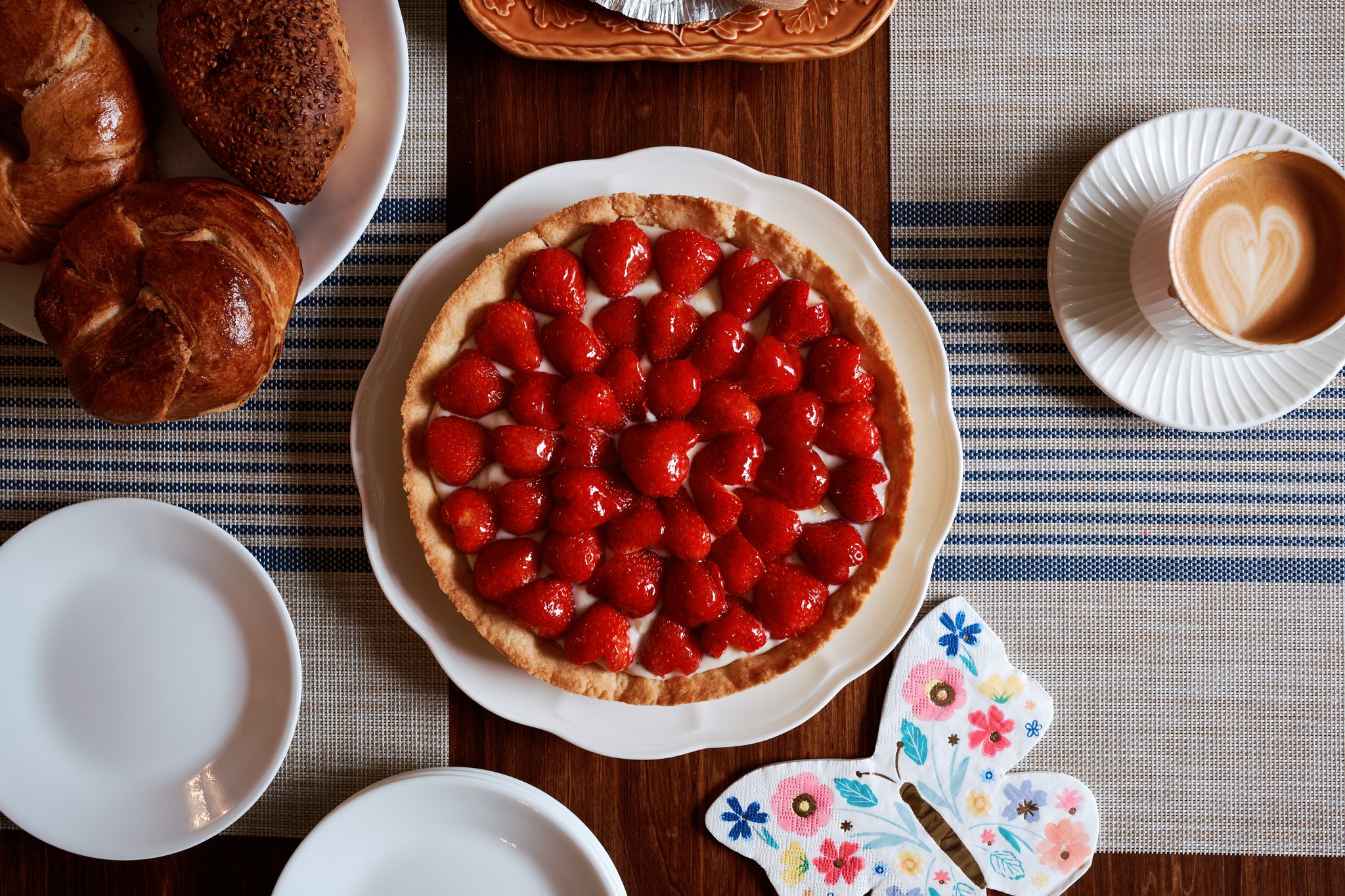 Ultra HDR version of the breakfast table with brighter glazed berries and white ceramics.