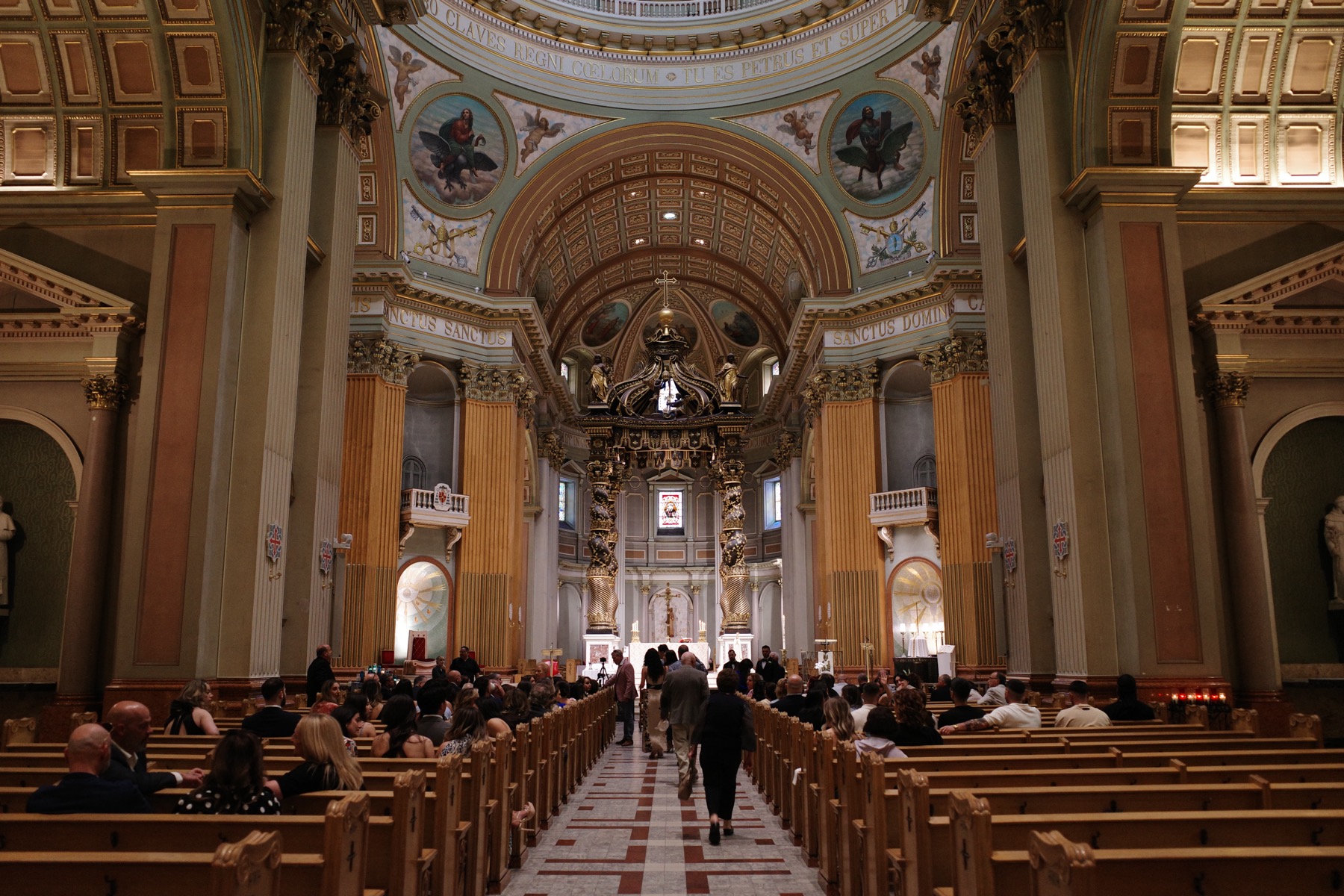 Ricoh GR III SOOC Positive Film JPEG of a cathedral interior with a long central aisle, warm wood pews, and bright chapel openings.